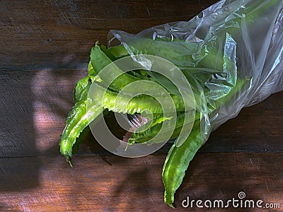 Winged beans or four-angled beans on wooden table Stock Photo