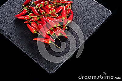 Bunch of red chillies on a plate and background Stock Photo