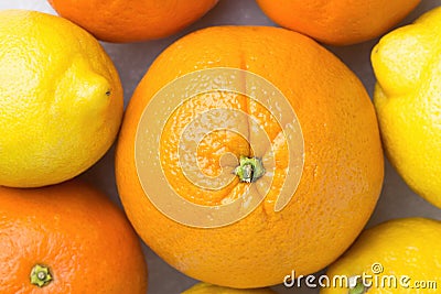 Bunch of Ripe Juicy Whole Citrus Fruits Oranges Tangerines Lemons on White Stone Marble Table. Vitamins Healthy Diet Summer Detox Stock Photo