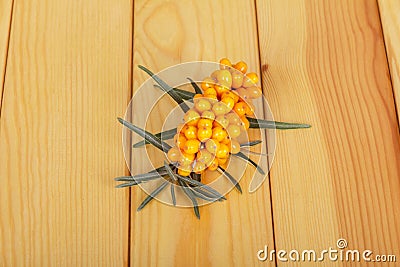 Bunch ripe sea-buckthorn berries on background light wood. Stock Photo