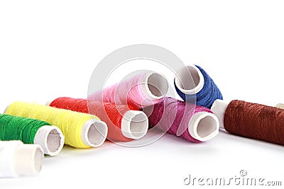 Bunch of rolls of colorful thread on a white surface Stock Photo