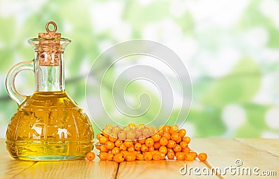 Bunch of sea buckthorn and oil bottle closeup Stock Photo