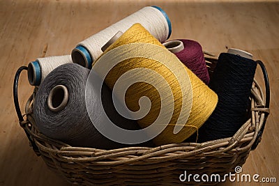 Bunch of Spools of Thread in Woven Basket Stock Photo