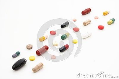 Bunch of variously colored generic medical pills and capsules arranged in rows isolated on white Stock Photo
