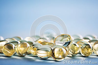 Bunch of vitamin D capsules laying on the table. Stock Photo