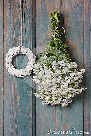 Bunch of white tiny chrysanthemums and white wicker wreath Stock Photo