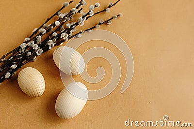 Bunch willow buds and flowers and wooden eggs on craft backgroun Stock Photo