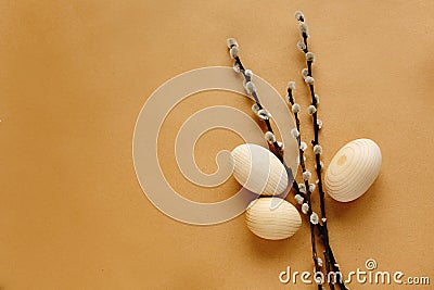 Bunch willow buds and flowers and wooden eggs on craft backgroun Stock Photo