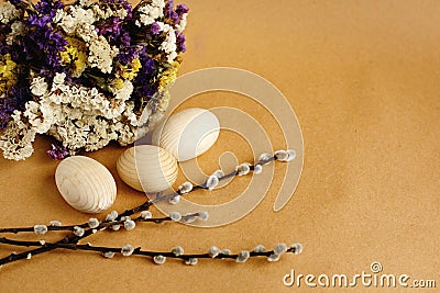 Bunch willow buds and flowers and wooden eggs on craft backgroun Stock Photo