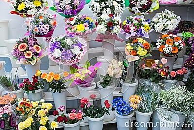 bunches of big fresh orange pink red gerbera chamomile rose and big white yellow blue chrysanthemum flower Stock Photo