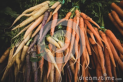 Bunches of organic rainbow carrots at a farmers market Stock Photo
