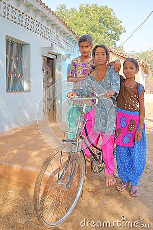 Portrait of three teenage girls posing in front of a traditional house in a village close to Bundi Editorial Stock Photo