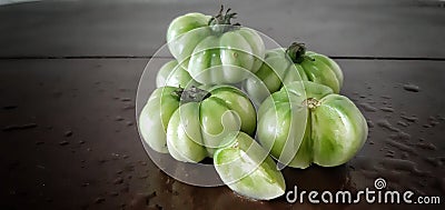 A bundle Green Fresh Tomatoes and a piece of Tomato Stock Photo