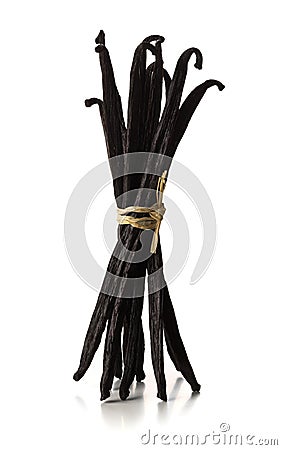 Bundle of tied, dried bourbon vanilla beans or pods standing over white background Stock Photo