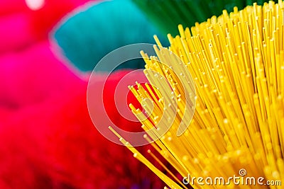 Bundle of traditional colorful Vietnamese incense sticks in a village workshop close to Hue city, Vietnam Stock Photo