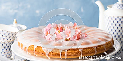 Bundt cake with frosting. Festive treat spring flowers banner Stock Photo