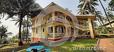 A bungalow near the beach surrounded by coconut trees Stock Photo