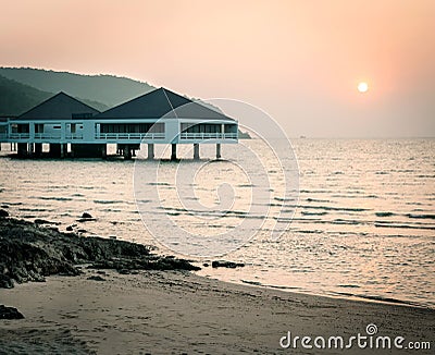 Bungalow near the sea with sunset Stock Photo