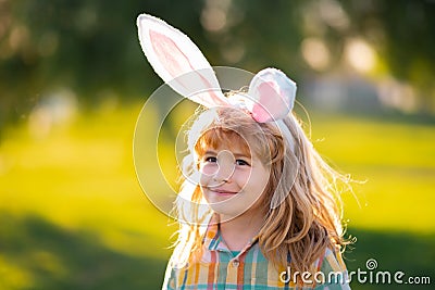 Bunny child boy face. Kids boy hunting easter eggs. Child in bunny ears hunt Easter eggs. Stock Photo