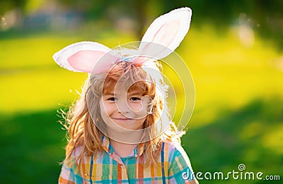 Bunny child. Child boy hunting easter eggs. Child boy with easter eggs and bunny ears in park. Stock Photo