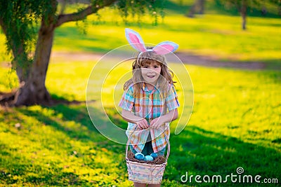Bunny child. Kids boy hunting easter eggs. Child in bunny ears hunt Easter eggs. Stock Photo