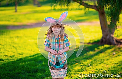 Bunny child. Kids boy hunting easter eggs. Child in bunny ears hunt Easter eggs. Stock Photo