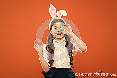 bunny is coming. small girl wear bunny ears. little kid in rabbit costume. spring holiday celebration. Easter eggs and Stock Photo