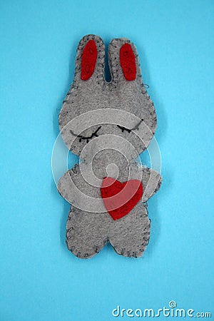 A bunny made of gray felt with a red heart Stock Photo