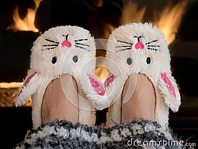 Bunny slippers by fireplace Stock Photo