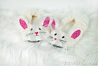 Bunny slippers on white fur Stock Photo