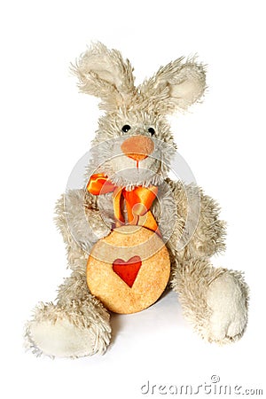 Bunny toy holding heart-shaped cookie Stock Photo