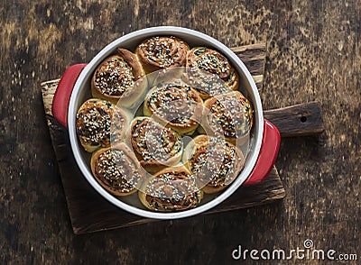 Buns stuffed with herbs and soft cream cheese on a wooden background, top view. Snack, appetizer rolls Stock Photo