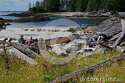 Kayakers relax on beach campsite after morning paddle in the Bunsby Islands Editorial Stock Photo