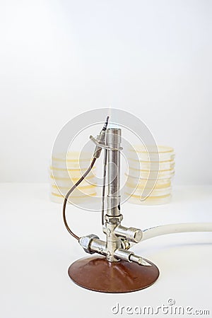 Bunsen burner with petri dishes Stock Photo