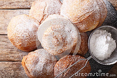 Bunuelos Mexican fritters sprinkled with powdered sugar close-up. horizontal top view Stock Photo