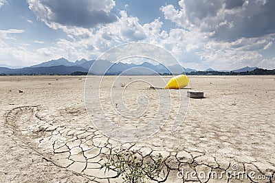 Buoy in the waterless Forggensee lake in Bavaria, Germany Stock Photo