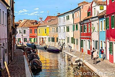 Burano island, Venice, Italy - September, 2017: Colorful houses in Burano near Venice, Italy with boats, canal and tourists. Editorial Stock Photo