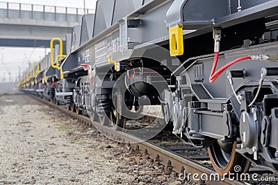 Burgas, Bulgaria - January 24, 2017. Freight cargo train - black cars wagons. New 6-axled flat wagon ,Type: Sahmmn, Model WW 6 Editorial Stock Photo