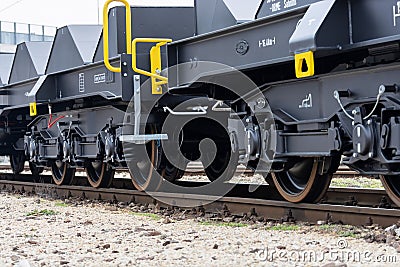 Burgas, Bulgaria - January 24, 2017. Freight cargo train - black cars wagons. New 6-axled flat wagon ,Type: Sahmmn, Model WW 6 Editorial Stock Photo