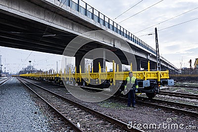 Burgas, Bulgaria - January 27, 2017 - Freight cargo train - yellow black New 4-axled flat cars wagons Type:Res Model:072-2- Transv Editorial Stock Photo