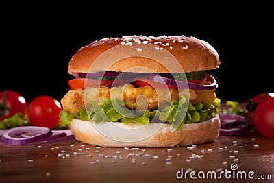 Burger with chicken, salad, cucumbers, tomatoes and onions. Stock Photo