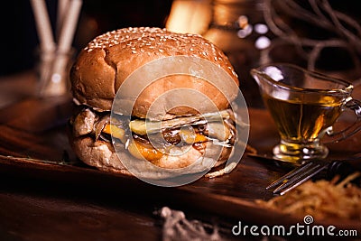 Burger food photo. Street food. Fresh tasty grilled beef hamburger cooked at barbecue on wooden table. Big cheeseburger Stock Photo