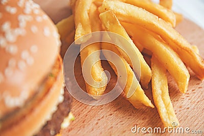 Burger and French fries on a wooden Board Stock Photo