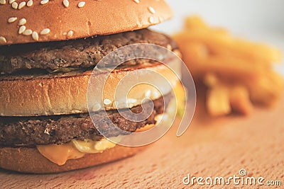 Burger and French fries on a wooden board Stock Photo