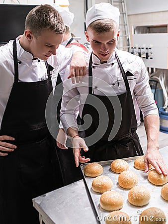 Burger rolls quality check communication teamwork Stock Photo