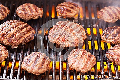 Burgers cooking on grill Stock Photo