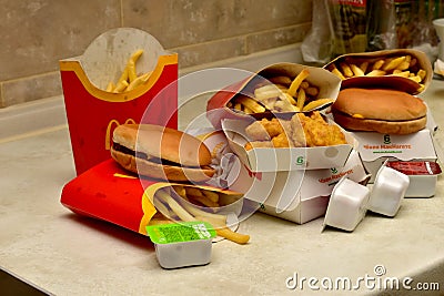 Burgers, fries and sauces on the table. Editorial Stock Photo