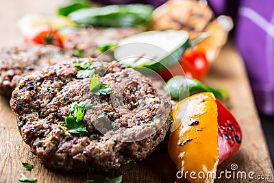 Burgers. Grill burgers. Minced burgers. Roasted burgers with grilled vegetable and herb decoration. Minced meat grilled in a hotel Stock Photo