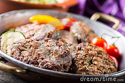 Burgers. Grill burgers. Minced burgers. Roasted burgers with grilled vegetable and herb decoration. Minced meat grilled in a hotel Stock Photo