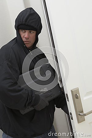 Burglar Stealing Laptop Stock Photo